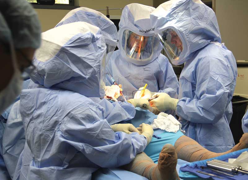 Elderly patient holding hip due to severe joint pain before hip replacement surgery treatment